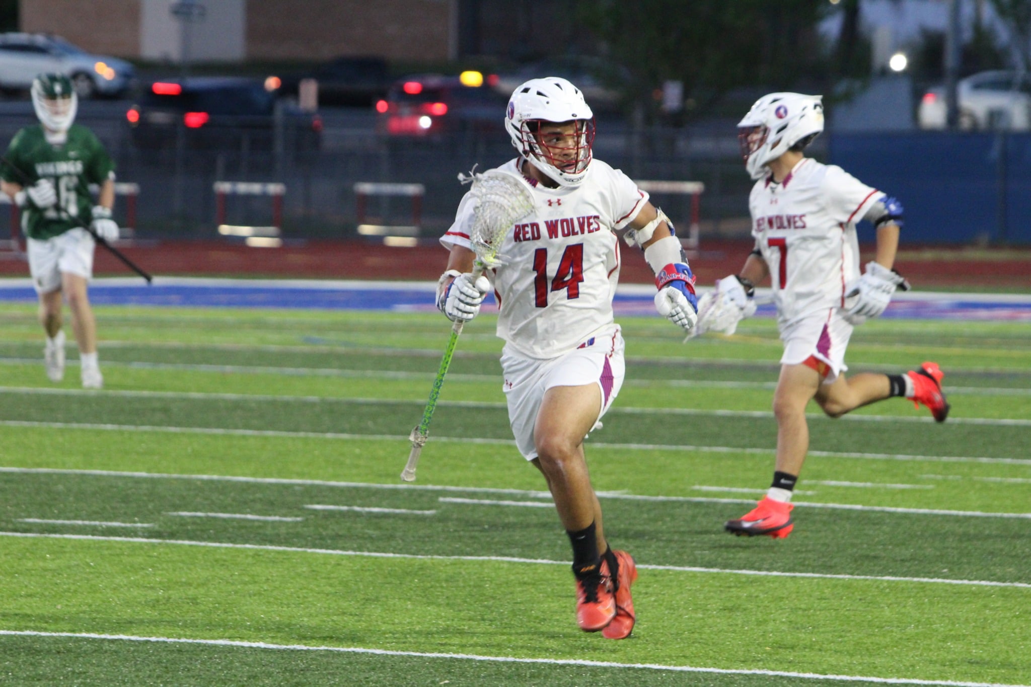 Two Lacrosse players running