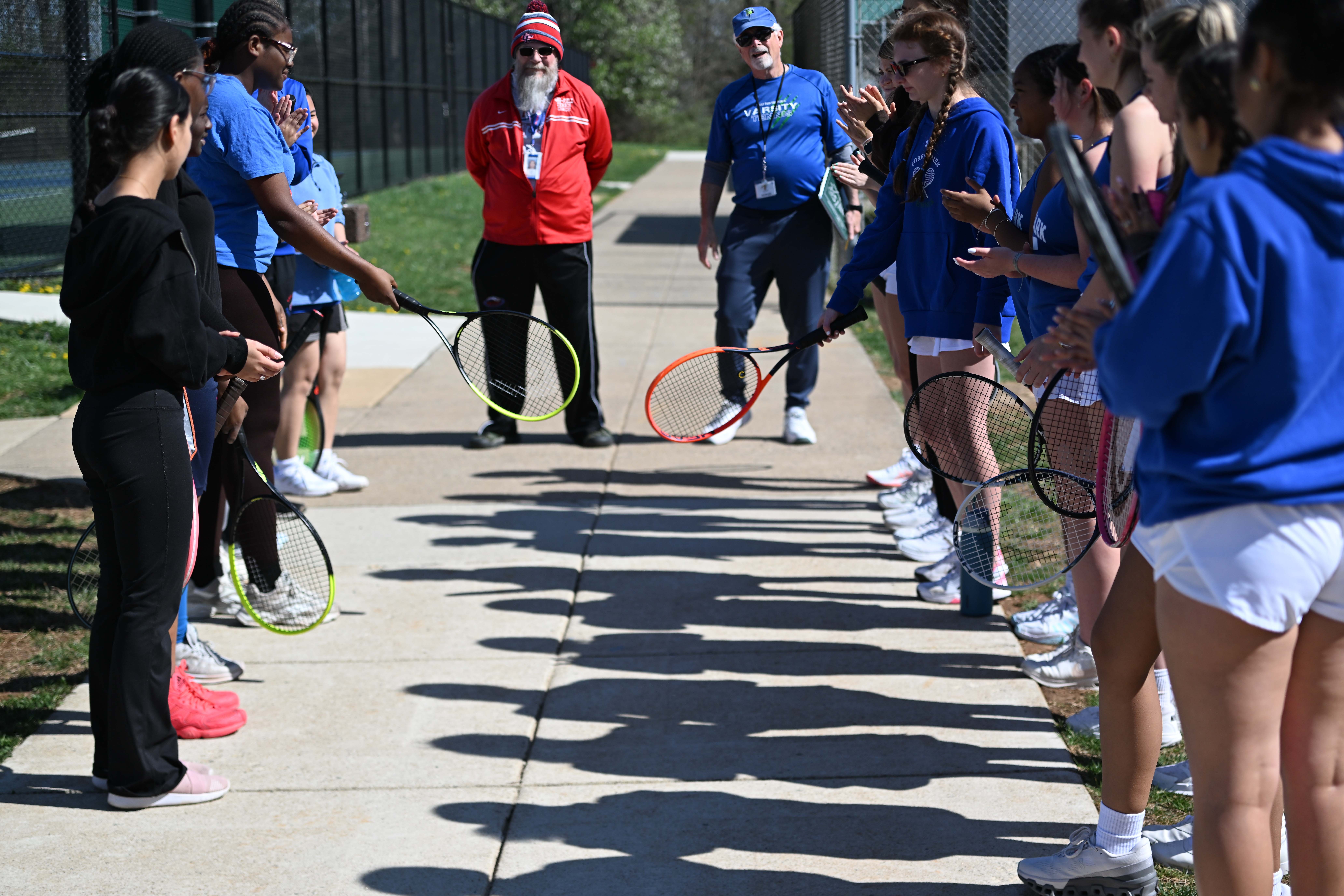 Pre-match team meeting between 2 tennis teams