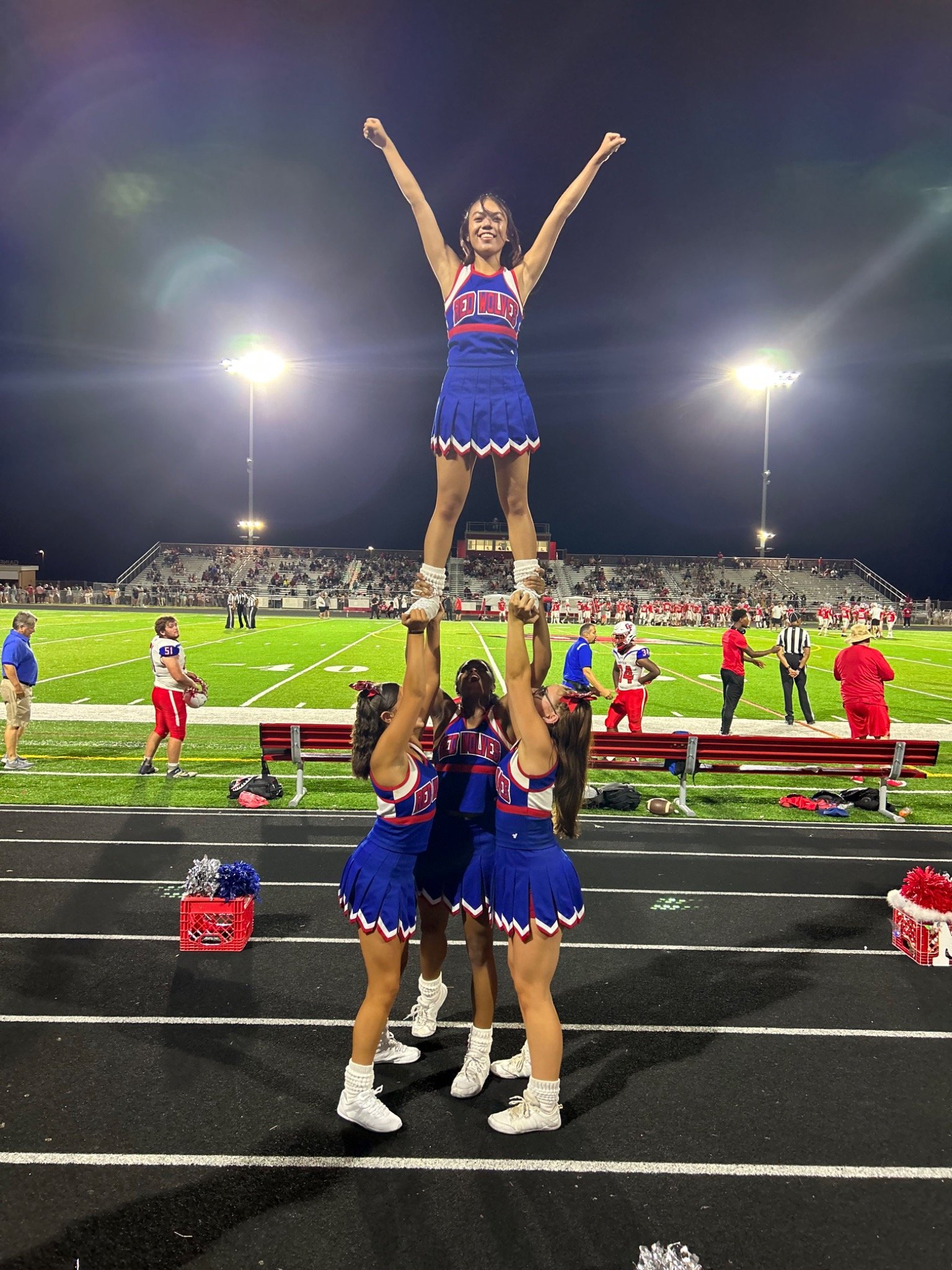 Cheerleaders performing a pyramid stunt