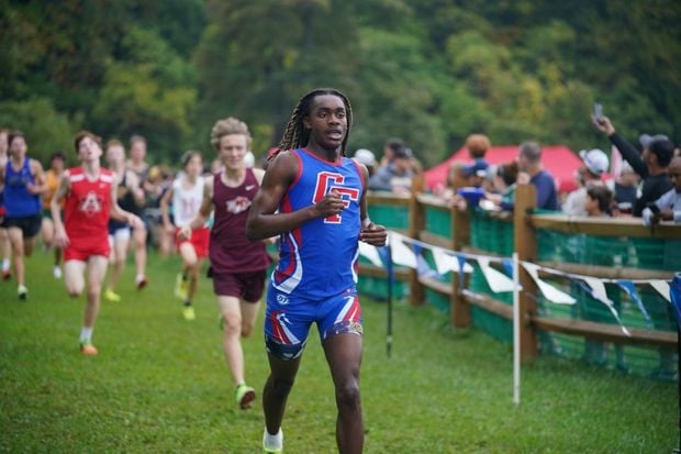 Male athlete running in a cross country race