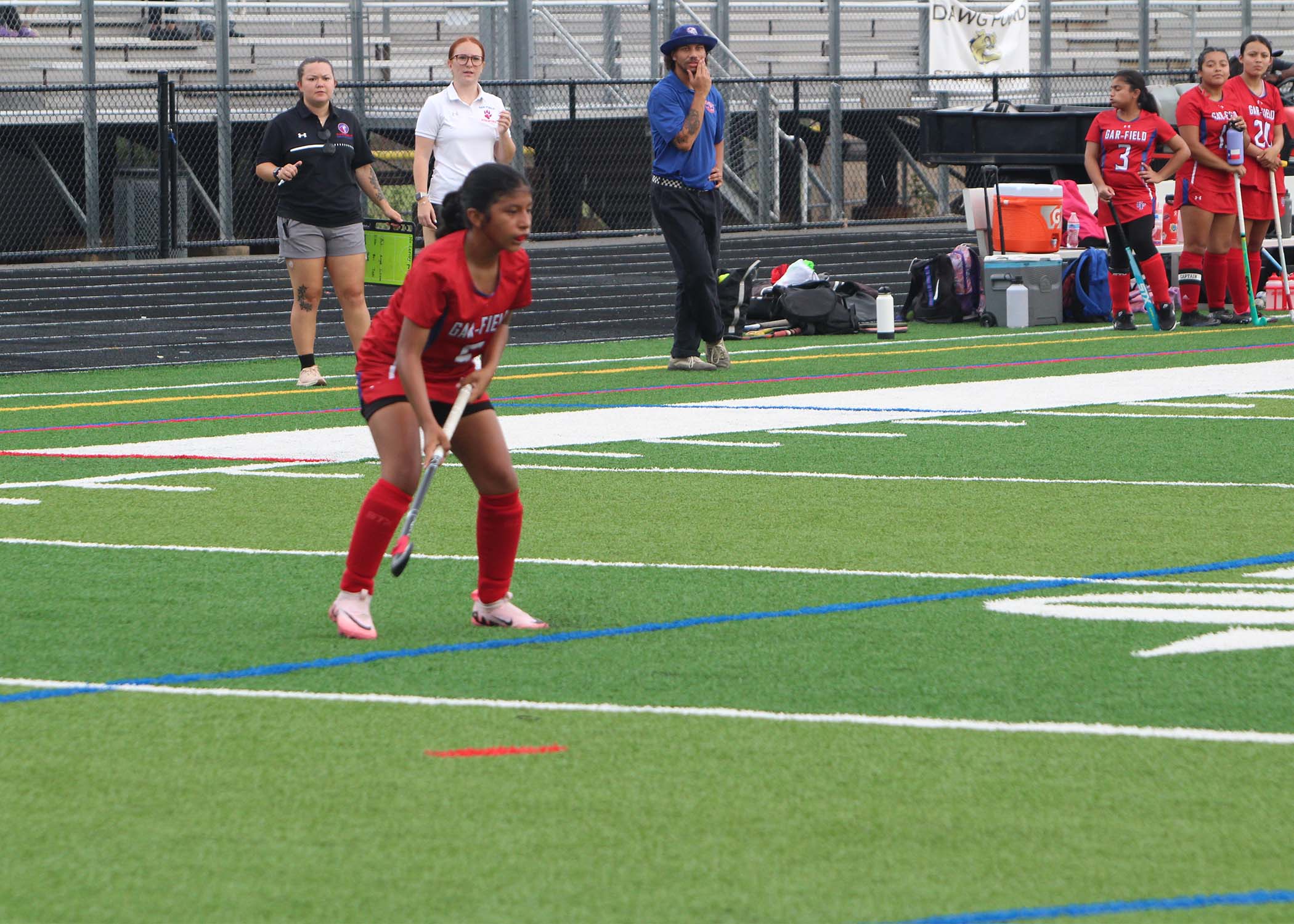 Athlete hitting field hockey ball