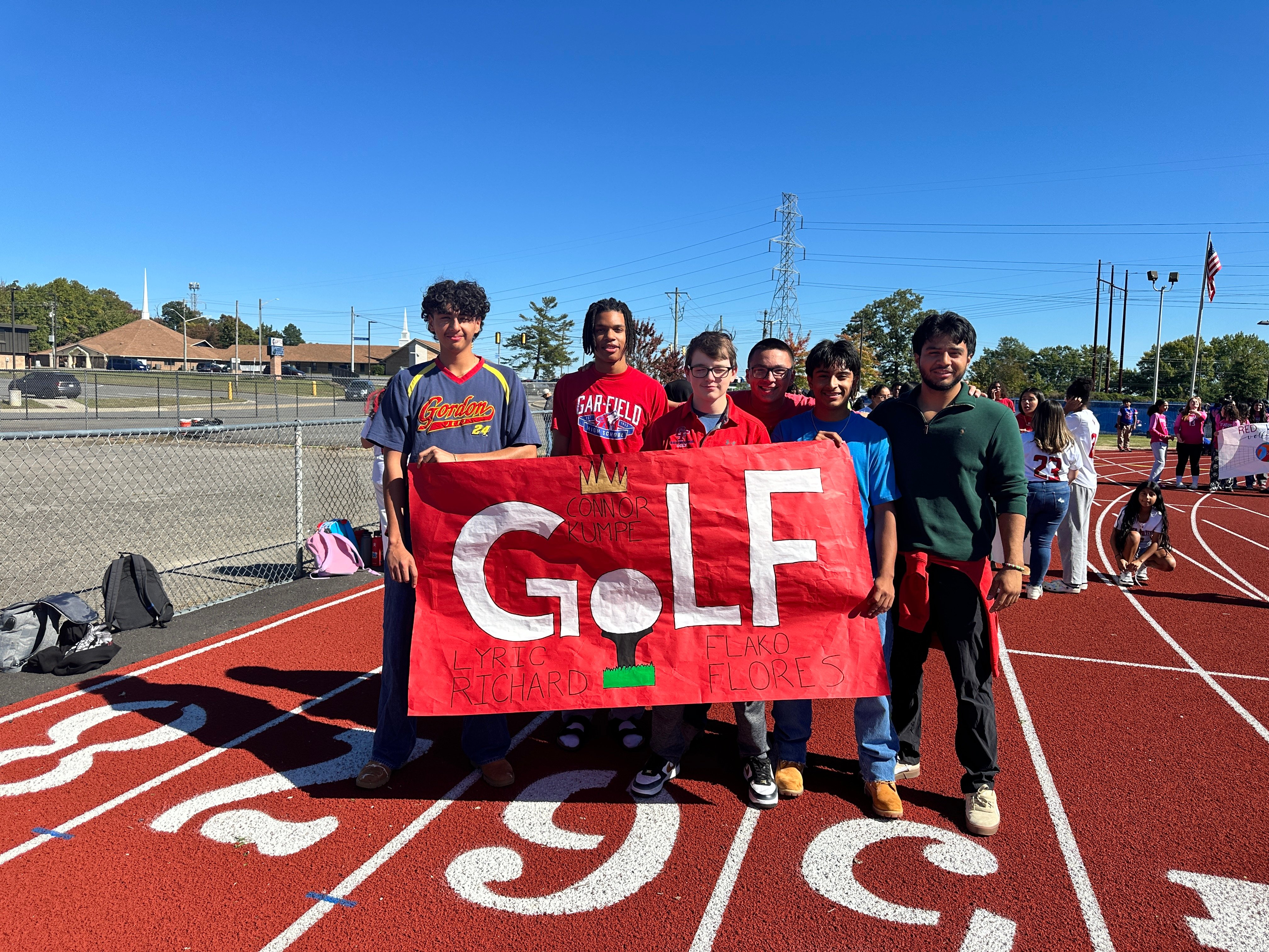 Golf team walking in the fall pep rally. 