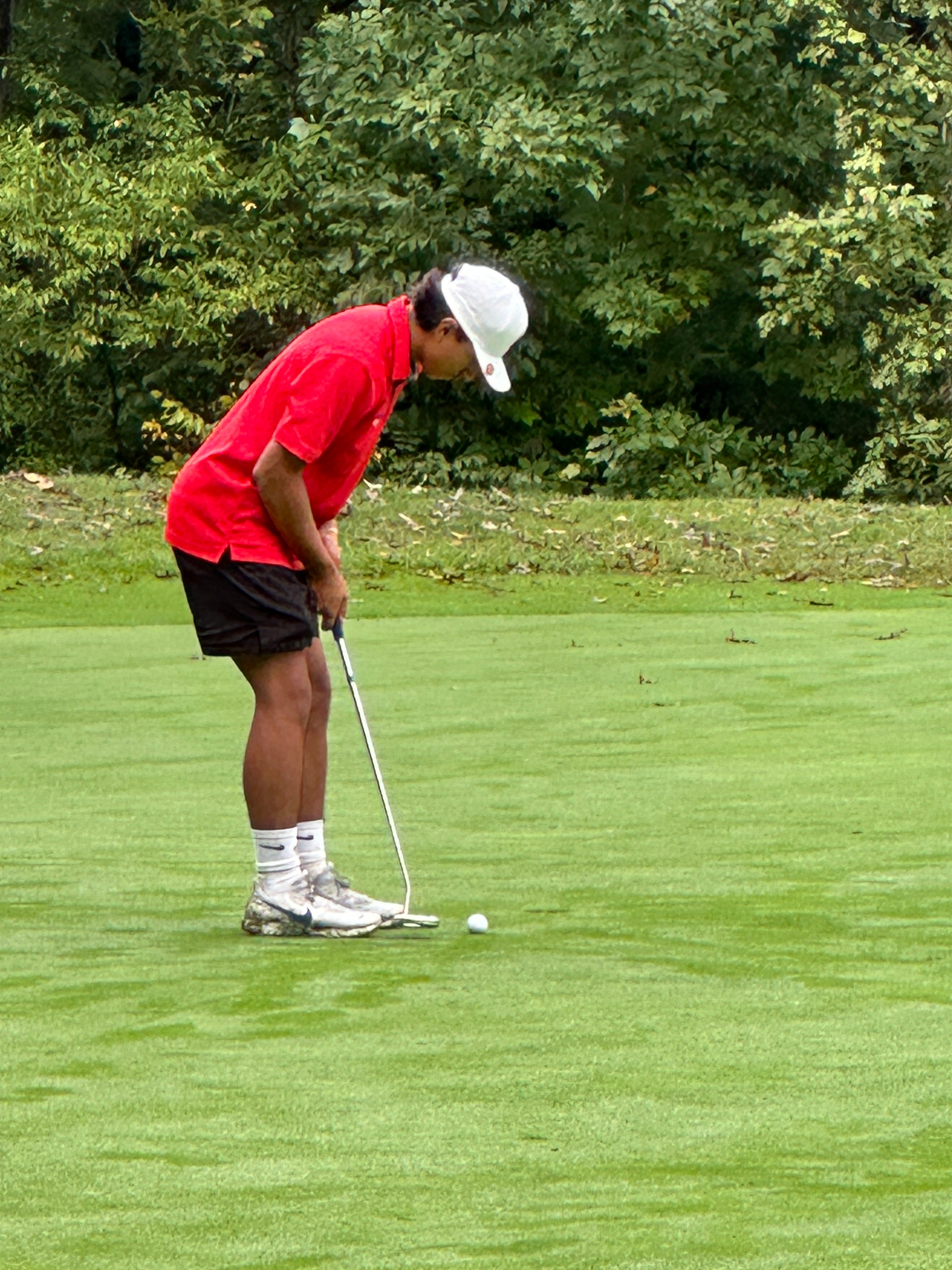 Student taking his drive on the tee box. 