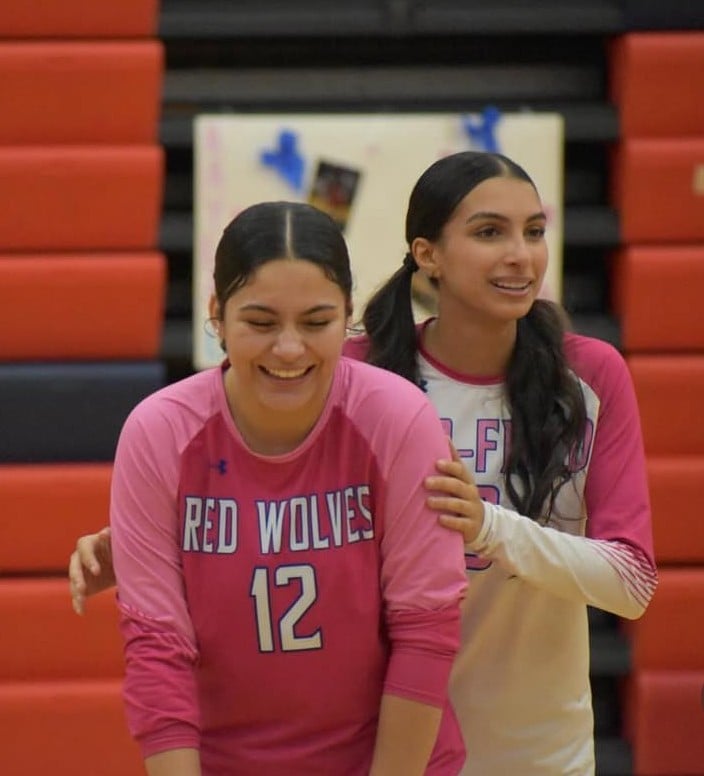 Players laughing and enjoying a volleyball game