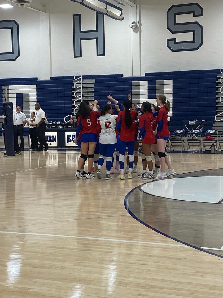 The volleyball team celebrating a point scored