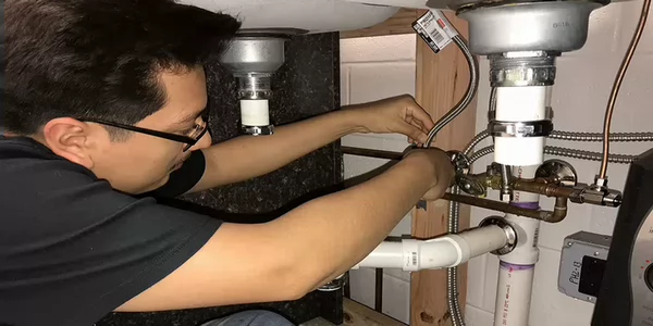 plumming student working on sink